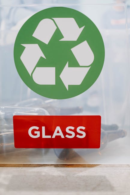 A large pile of flattened cardboard boxes and packaging materials scattered on a surface, including various sizes and colors such as brown, white, pink, and blue. Some boxes display printed logos or t